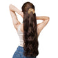 Woman with long, wavy hair tied back with a scrunchie on a white background